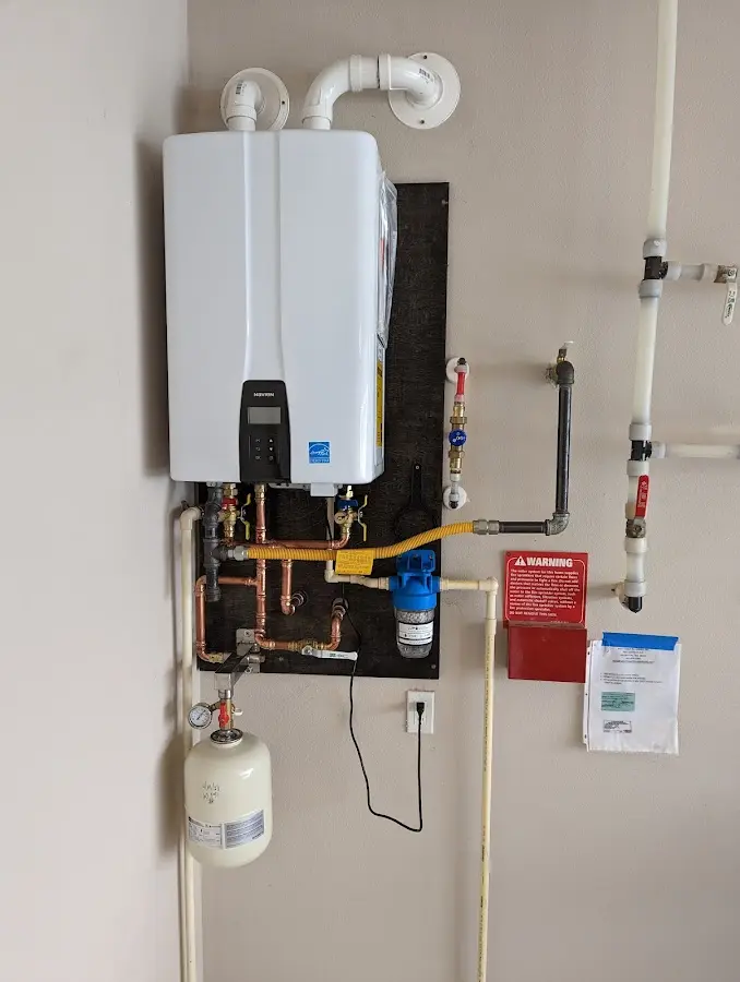 Professional plumber installing copper piping in a Kalkaska home